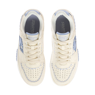 Women's low-top sneaker front view with blue tongue lining and lace-up
