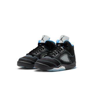 Pair of kids' black retro sneakers with blue accents and perforated side panels