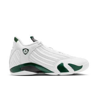 White low-top sneakers with green accents and black outsole detail