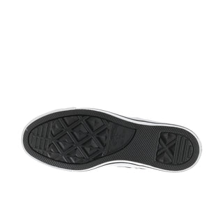 Black outsole tread of women’s low-top sneakers with white midsole edge.