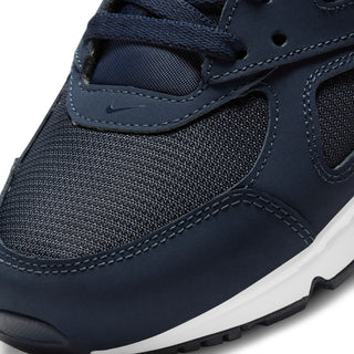 Navy sneaker upper close-up with mesh texture, lace eyelets, and contrast stitching