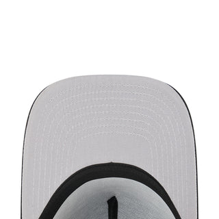 Light gray cap top close-up with black circular trim and stitched panels
