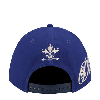 Blue baseball cap top view with embroidered fleur-de-lis and script side graphics