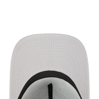 Light gray baseball cap crown close-up with black brim edge stitching