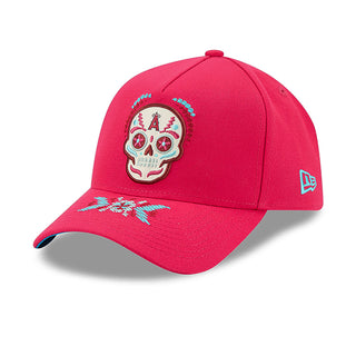 Red baseball cap with Dia de Muertos skull patch and New Era logo on side