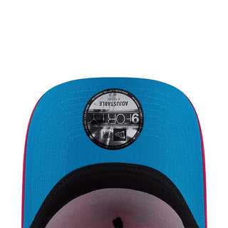 Blue baseball cap front with black circular label, mesh texture, and gray underbrim