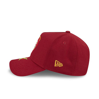 Red A-frame baseball cap with small gold New Era flag logo on the side