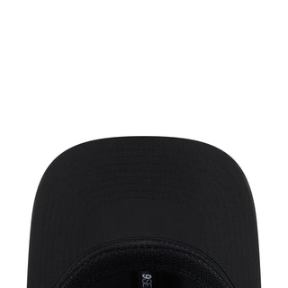 Black cap crown close-up with stitched panels and ventilation eyelets