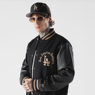 Men's black varsity jacket with LA crest on chest and striped rib collar and sleeve cuffs.