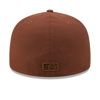 Brown baseball cap back view with small rectangular logo patch