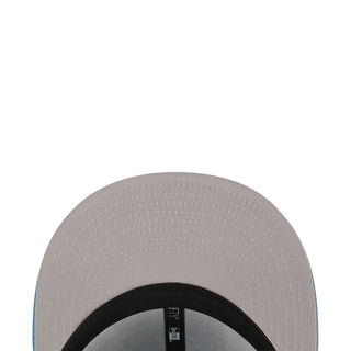Light-colored baseball cap crown close-up with stitched panel
