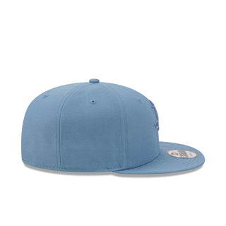 Faded blue baseball cap with flat brim and New Era side badge