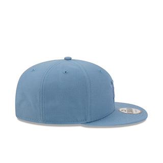 Faded blue baseball cap with snapback closure and stitched ventilation eyelets