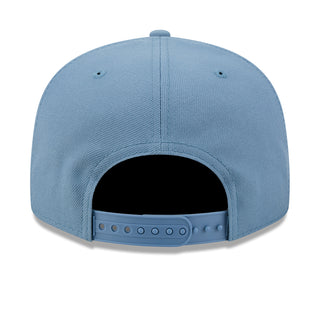 Faded blue snapback baseball cap with open back and adjustable plastic strap