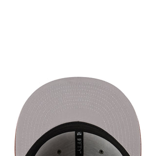 Two-tone baseball cap close-up, light gray fabric with black inner band and vent holes