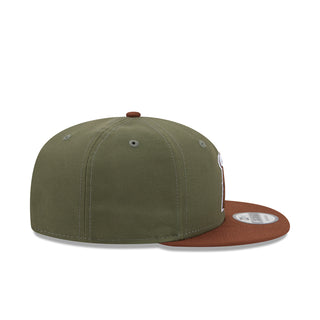 Olive two-tone baseball cap with brown undervisor and small side emblem