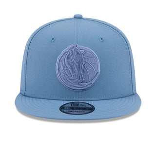 Faded blue baseball cap with embroidered emblem on the front panel