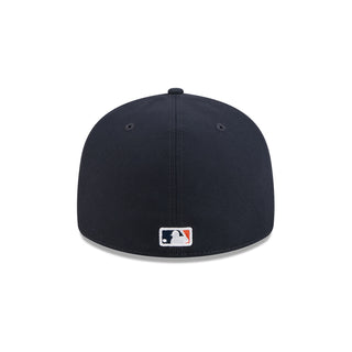 Navy baseball cap back view with small square logo patch
