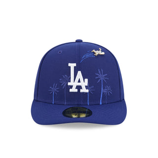 Blue baseball cap with LA logo, palm-tree embroidery, and bird pin on front panel.