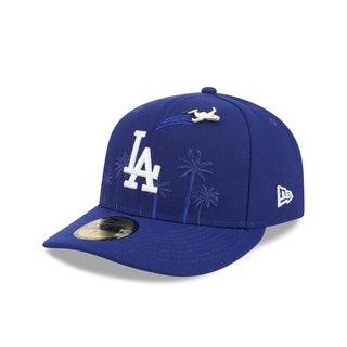 Blue baseball cap with LA logo, bird pin, palm-tree embroidery, and New Era side logo.