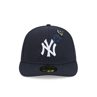 Navy baseball cap with white NY logo and gold bird pin on front panel