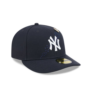 Navy baseball cap with white NY logo and gold bird pin, angled side view