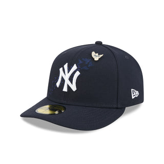 Navy baseball cap with white NY logo, gold bird pin, and New Era flag