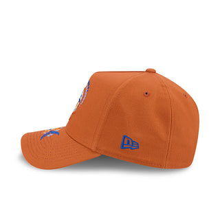 Rust baseball cap with small blue team logo on front panel