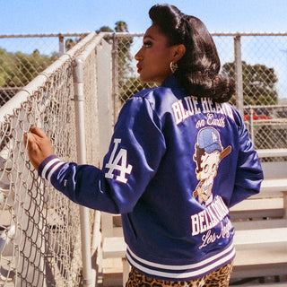 Royal blue satin varsity jacket back view with cartoon print, Los Angeles text, striped cuffs