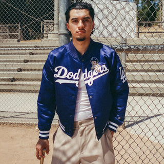 Royal blue varsity jacket with Dodgers script front, snap placket, striped cuff and hem