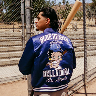 Royal blue jacket back print featuring cartoon character, text "Blue Heaven on Earth", rib hem