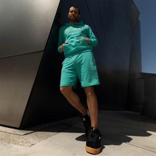 Men's teal shorts with PUMA logo detail and side seam stitching