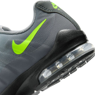 Youth sneaker side close-up with neon green Swoosh and clear air unit in sole