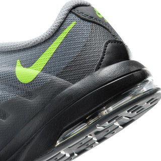 Close-up of kids' grey sneaker side with neon green Swoosh and air-window sole