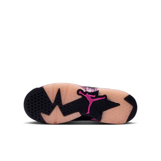 Black rubber outsole of youth low-top sneakers with pink Jumpman branding