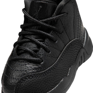 Black toddler high-top sneaker close-up with lace-up, textured leather, and stitching