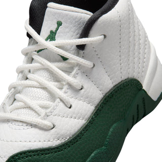 Toddler sneaker upper close-up with white laces, green side logo, and textured panels