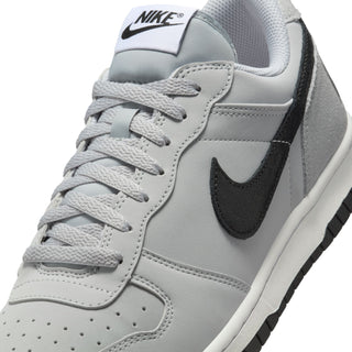 Men's Nike low-top sneakers close-up, light gray leather with black swoosh