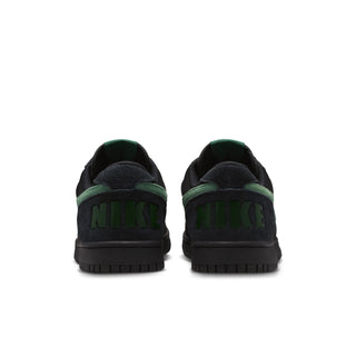 Black Nike sneakers with green heel pull tabs and cushioned collar.