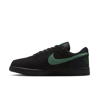 Black Nike low-top sneaker with green Swoosh and lace-up upper.