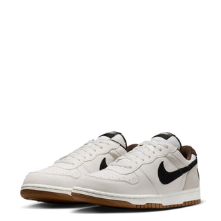 Pair of men's Nike low-top sneakers, white uppers with black swooshes and gum soles