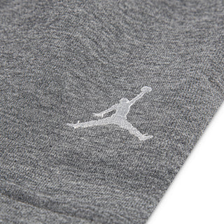 Close-up of white Jordan logo on carbon heather youth fleece cargo pants