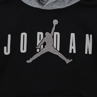Close-up: black hoodie chest with Jumpman logo and JORDAN lettering in white