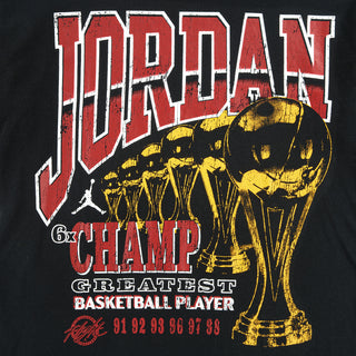 Youth black Jumpman graphic T-shirt with large red Jumpman text and gold trophy