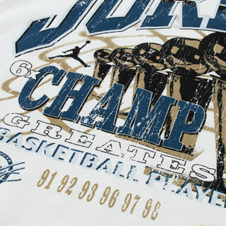 White youth graphic T-shirt close-up of navy, black, and gold basketball lettering