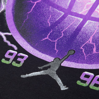 Close-up of the tee's purple basketball print, year numbers, and silver Jumpman logo