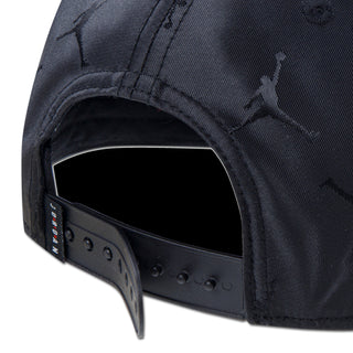 Youth black snapback cap close-up of adjustable strap with hole row