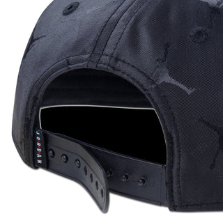 Youth black snapback cap close-up of adjustable snap strap and stitching