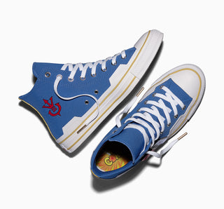 Side view of blue high-top sneakers with white laces, yellow stripes, and graphic insole lining