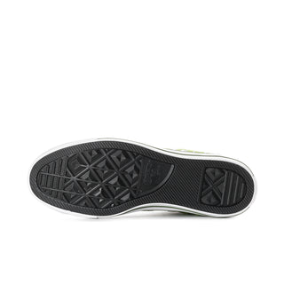 Outsole view of bright green high-top sneakers with black tread and white midsole